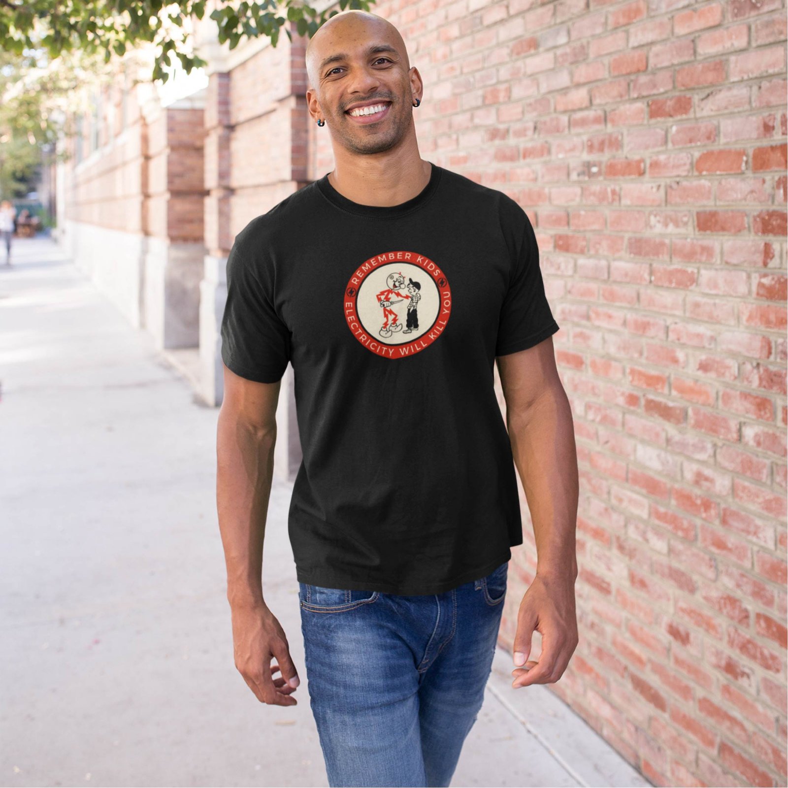Man wearing a black T-shirt with retro electricity safety badge